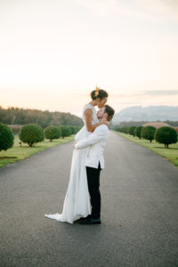 Bride kissing groom on forehead in front of the Del Mar Villa in Dundee, Oregon