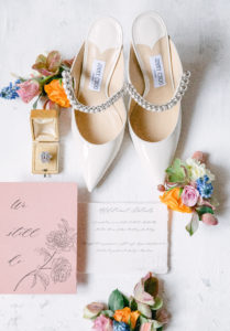 Details of flatlay consists Jimmy Choo, ring box and invitation suite at Lairmont Manor in Bellingham, WA