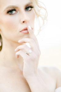 Beautiful bride with blue hand touch lips wearing princess cut diamond ring