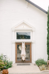 Bride Dress hang at the front door of Old School House in Newberg, OR