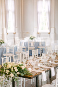 Table decoration with french blue linen and white chairs inside The Old School House in Newberg, OR