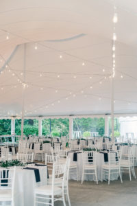 Reception area under the tent with white tables and chairs at Abernathy Center in Oregon City