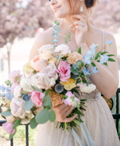 Bride holing a blush and colorful bridal bouquet at Wadely Farms in Linton, Utah