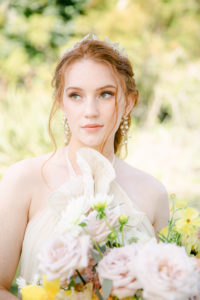 Makeup for red head and fair skin brides, wearing headpiece by Grace de Bloom and halter chiffon dress by Shopgossamer, holding bridal bouquet